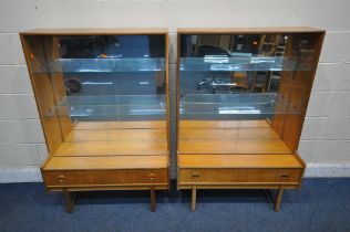 TURNIDGE OF LONDON, A PAIR OF MID CENTURY TEAK BOOKCASES, with double glazed doors, enclosing a