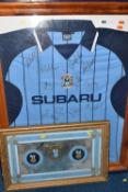 A FRAMED AND GLAZED SIGNED COVENTRY CITY FOOTBALL SHIRT, signed to the front in marker pen by the