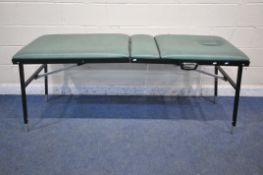 A FOLDING MASSAGE TABLE, with face rest hole, height adjustable backrest and legs, open length 197cm