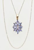 A 9CT GOLD TANZANITE AND DIAMOND PENDANT, designed as a cluster of marquise shape tanzanite with