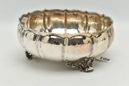 A WHITE METAL BOWL, a large bowl raised on three feet, hammered finish with twisted rope detail,