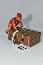 A GESCHA TIN PLATE 'EXPRESS BOY' CLOCKWORK TOY, the boy wearing a red uniform, pushing a trunk,