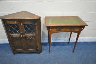 AN ARTS AND CRAFTS OAK SIDE TABLE, with a green leather inlay, above a single drawer, on cylindrical