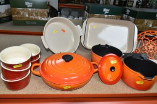 A GROUP OF LE CREUSET VOLCANIC ORANGE PANS AND OVENWARE, comprising two saucepans size 16, a covered