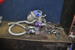 A DYSON DC31 HANDHELD VACUUM with wall bracket, charger and a quantity of accessories along with a