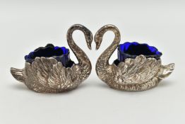 A PAIR OF GEORGE V SILVER NOVELTY SALTS, matching swans with feather detail, with blue glass