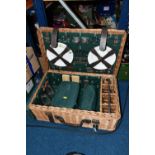 A WICKER PICNIC HAMPER/SET, a large hamper containing a set of four wine glasses, four plates,