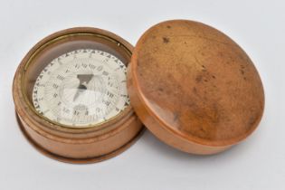 A TREEN POCKET COMPASS, approximate width 54.8mm, instructions label to the base (condition