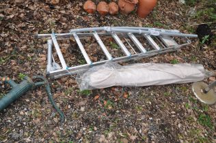 A GARDEN PARASOL WITH WIND AND TILT MECHANISM approx. 280cm across, an aluminium step ladder and a