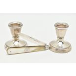 A PAIR OF SILVER DWARF CANDLE STICKS AND A FRUIT KNIFE, polished tapered candle sticks, on round