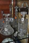 A GROUP OF DECANTERS AND STOPPERS, comprising a square decanter with silver collar, hallmarked