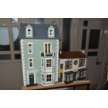 TWO DOLL'S HOUSES, comprising a large Georgian kit built house, partially decorated, and a mid