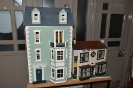TWO DOLL'S HOUSES, comprising a large Georgian kit built house, partially decorated, and a mid