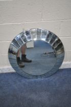 AN R V ASTLEY CIRCULAR WALL MIRROR, with bevelled mirror segment frame, diameter 78cm (condition