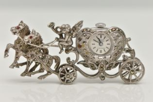 A WHITE METAL WATCH BROOCH, designed as a carriage with a cherub and two horses, set with marcasite,