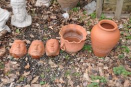 THREE MODERN TERRACOTTA FACE MASK WALL MOUNTED PLANTERS AND TWO PLANTERS the masks are 19cm high(5)