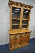 AN EARLY TO MID 20TH CENTURY OAK BOOKCASE, the top fitted with double glazed doors, that are