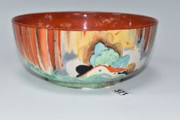 A CLARICE CLIFF 'FOREST GLEN' PATTERN BOWL, painted with a cottage landscape on an orange-red