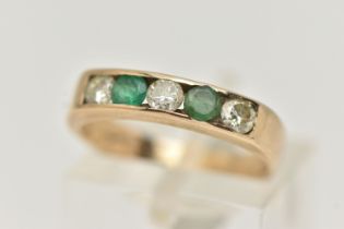 A 9CT GOLD EMERALD AND DIAMOND HALF ETERNITY RING, set with three round brilliant cut diamonds,