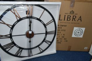A BOXED 'LIBRA' UNUSED WALL CLOCK, a black and bronze coloured metal wall clock with Roman numerals,