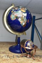 TWO MODERN HARDSTONE EFFECT TERRESTRIAL GLOBES, one on a blue plinth, approx. height 65cm, the other
