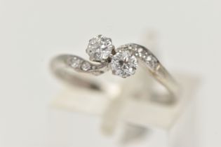 A TWO STONE DIAMOND RING, two old cut diamonds prong set in white metal, flanked with four old cut