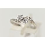 A TWO STONE DIAMOND RING, two old cut diamonds prong set in white metal, flanked with four old cut