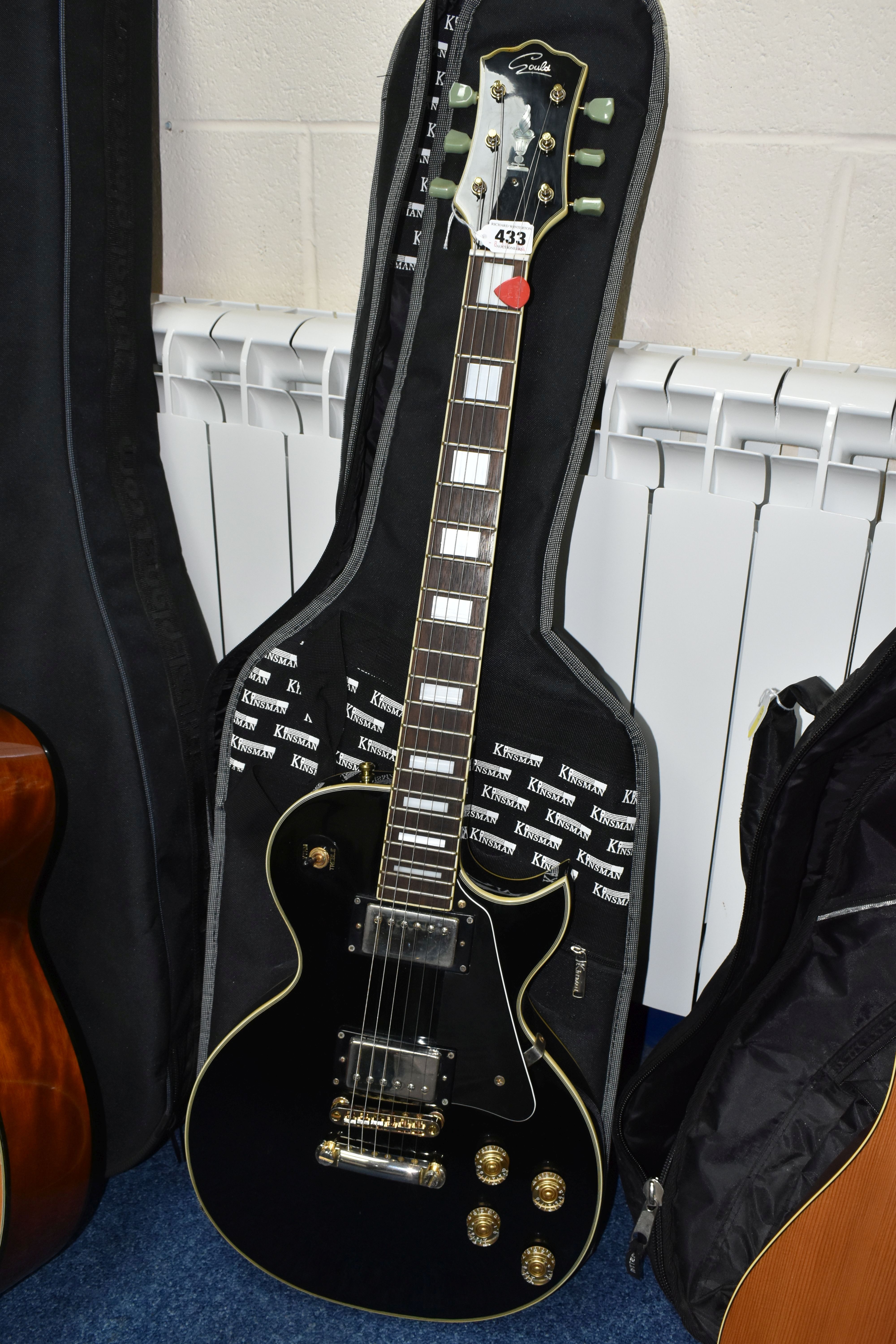 A GOULD ELECRIC GUITAR, black and gold body, with a Kinsman soft case (1) (Condition Report: small