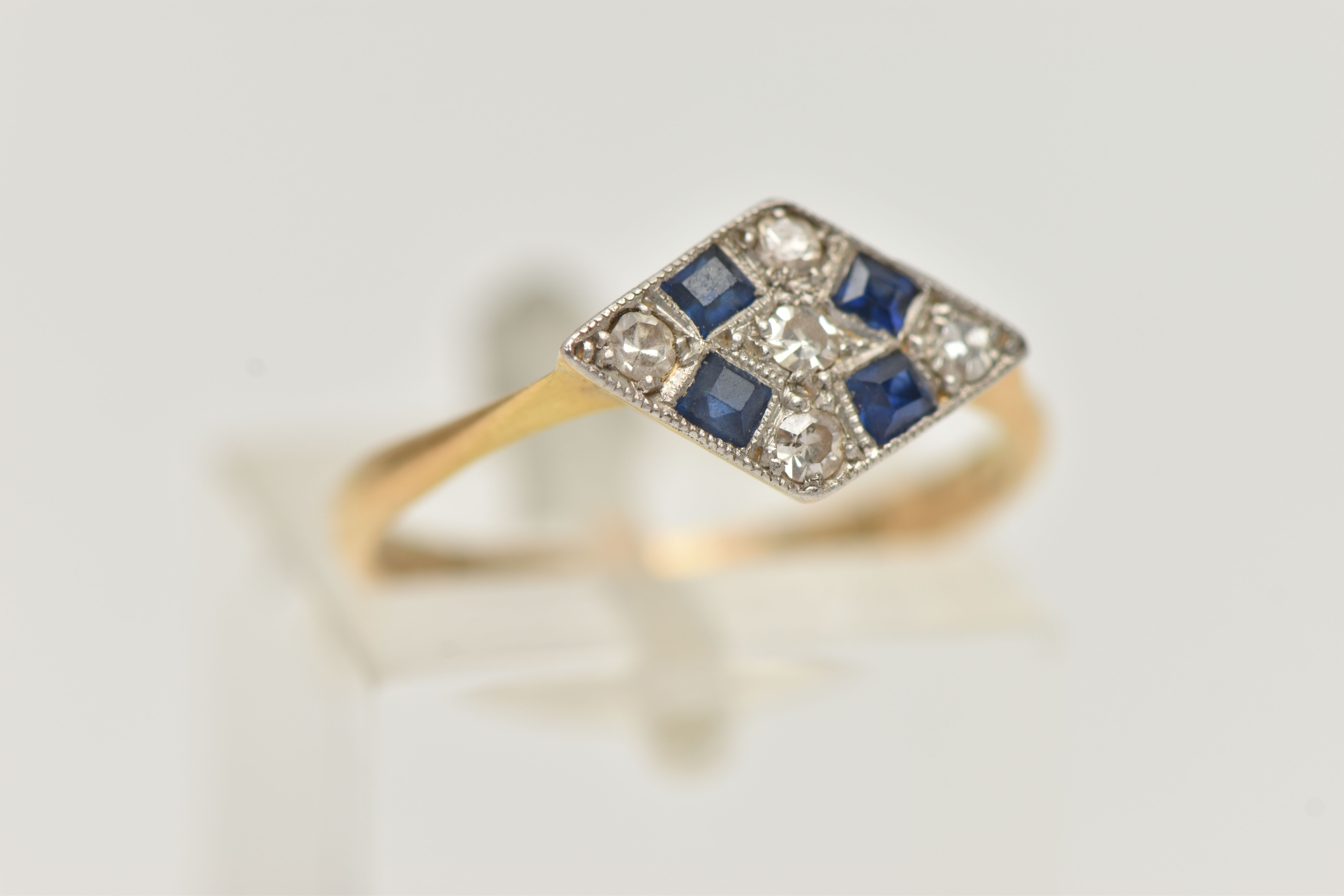 A LATE ART DECO SAPPHIRE AND DIAMOND RING, a rhombus form white metal mount, set with four square - Image 4 of 4