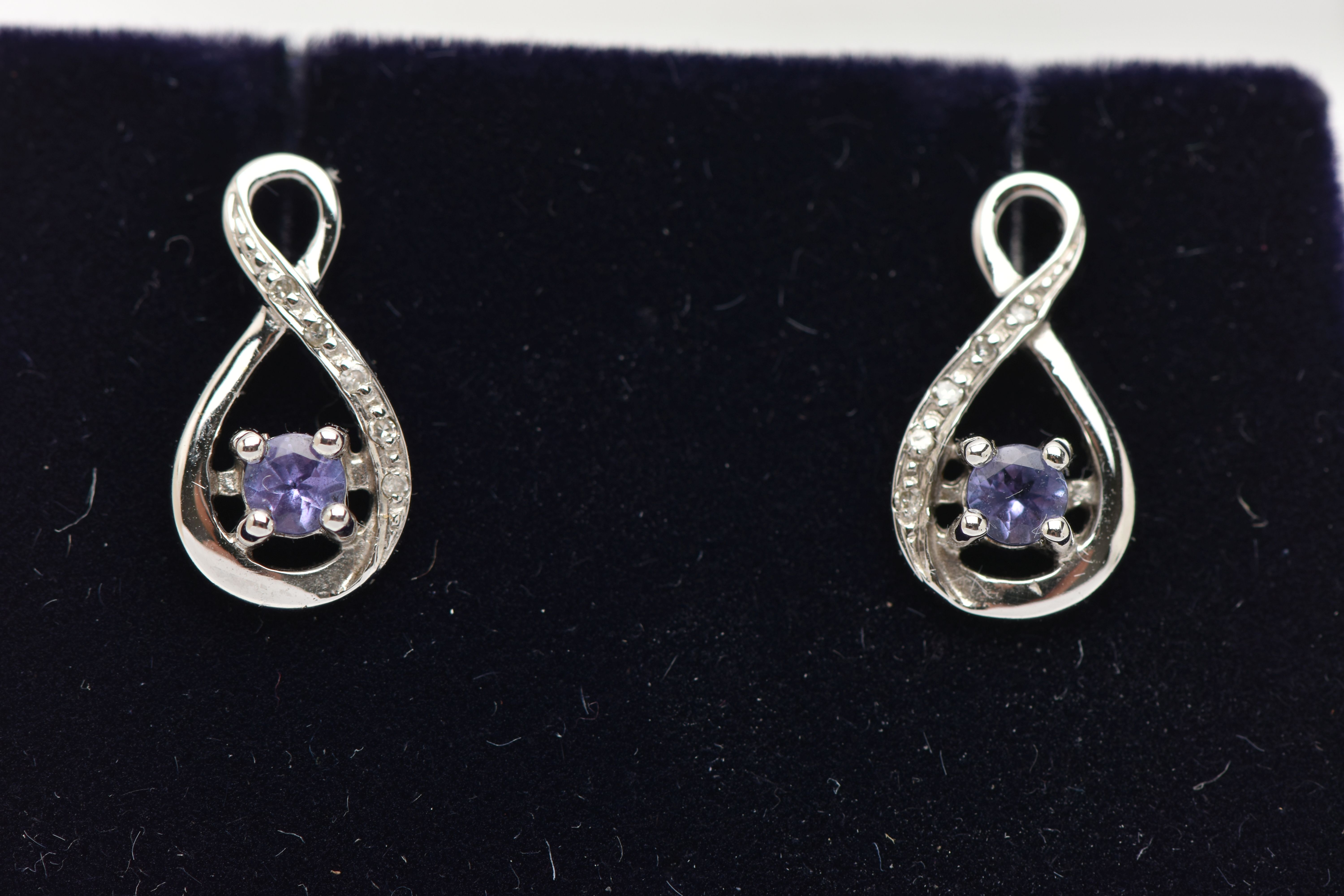 A BOXED PAIR OF 9CT WHITE GOLD TANZANITE AND DIAMOND SET EARRINGS, each earring set with a small