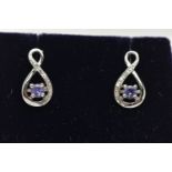 A BOXED PAIR OF 9CT WHITE GOLD TANZANITE AND DIAMOND SET EARRINGS, each earring set with a small