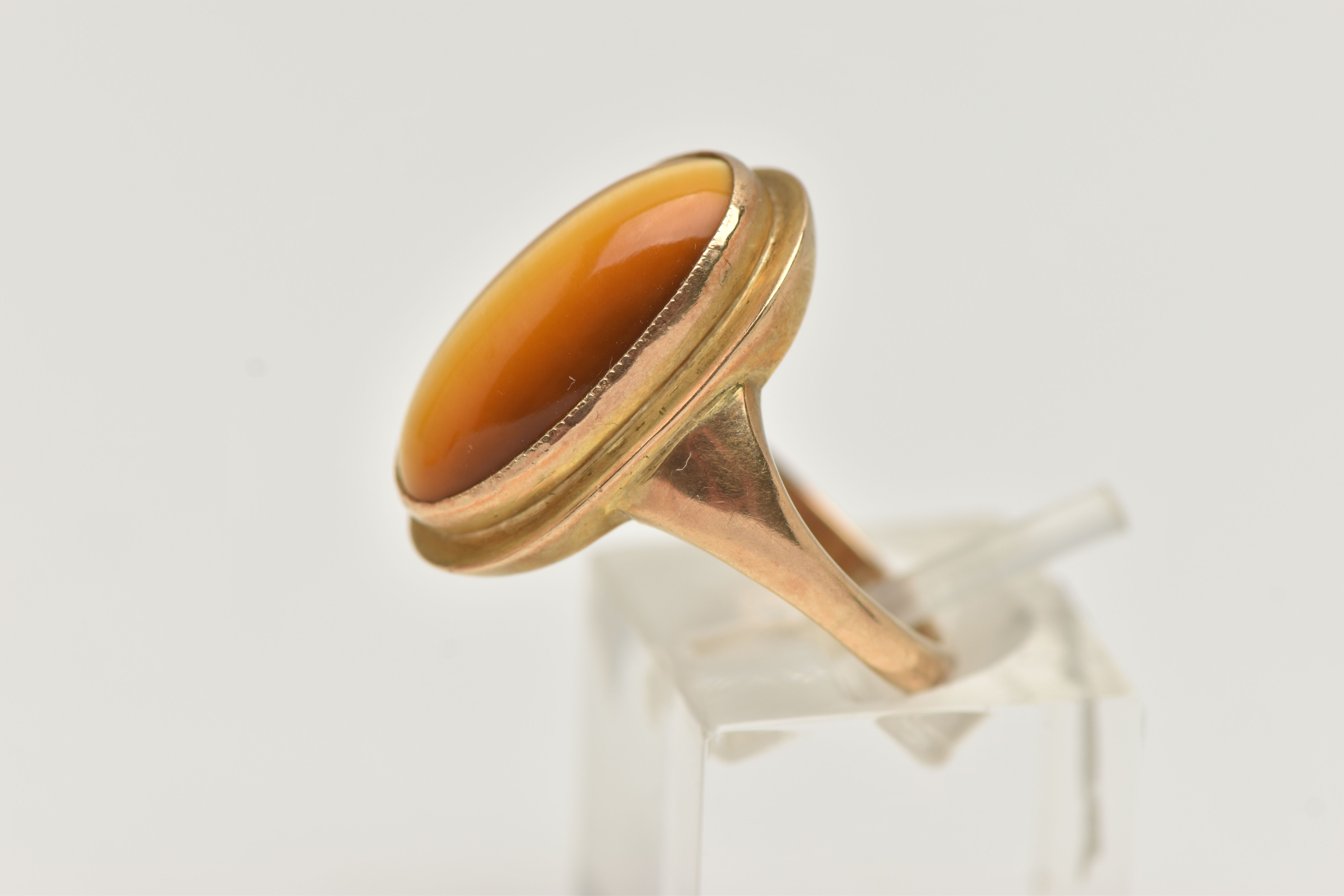 A 9CT GOLD DRESS RING, an elongated oval cabochon tigers eye, collet set in yellow gold, leading - Image 2 of 5