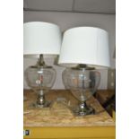 TWO MODERN TABLE LAMPS, with glass bodies and cream shades, height to top of fitting approximately