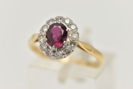 A RUBY AND DIAMOND CLUSTER RING, a principally set oval cut ruby, prong set in white metal, with a