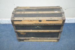 A DOMED TRAVELING TRUNK, with wooden and metal banding, twin handles and a hinged lid, width 77cm