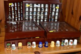 A COLLECTION OF THIMBLES, comprising seven wooden display cabinets and approximately four hundred