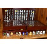 A COLLECTION OF THIMBLES, comprising seven wooden display cabinets and approximately four hundred