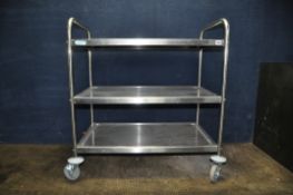 A MODERN 'VOGUE' RETRO MEDICAL STYLE TROLLEY with three dished stainless steel shelves and wheels to