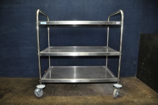 A MODERN 'VOGUE' RETRO MEDICAL STYLE TROLLEY with three dished stainless steel shelves and wheels to