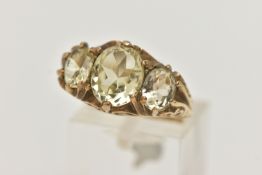 A 9CT GOLD GEM SET RING, three light yellow oval cut quartz stones, prong set in yellow gold,