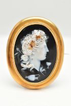 A LARGE YELLOW METAL CAMEO BROOH, glass cameo depicting a lady in profile with grapes in hair,