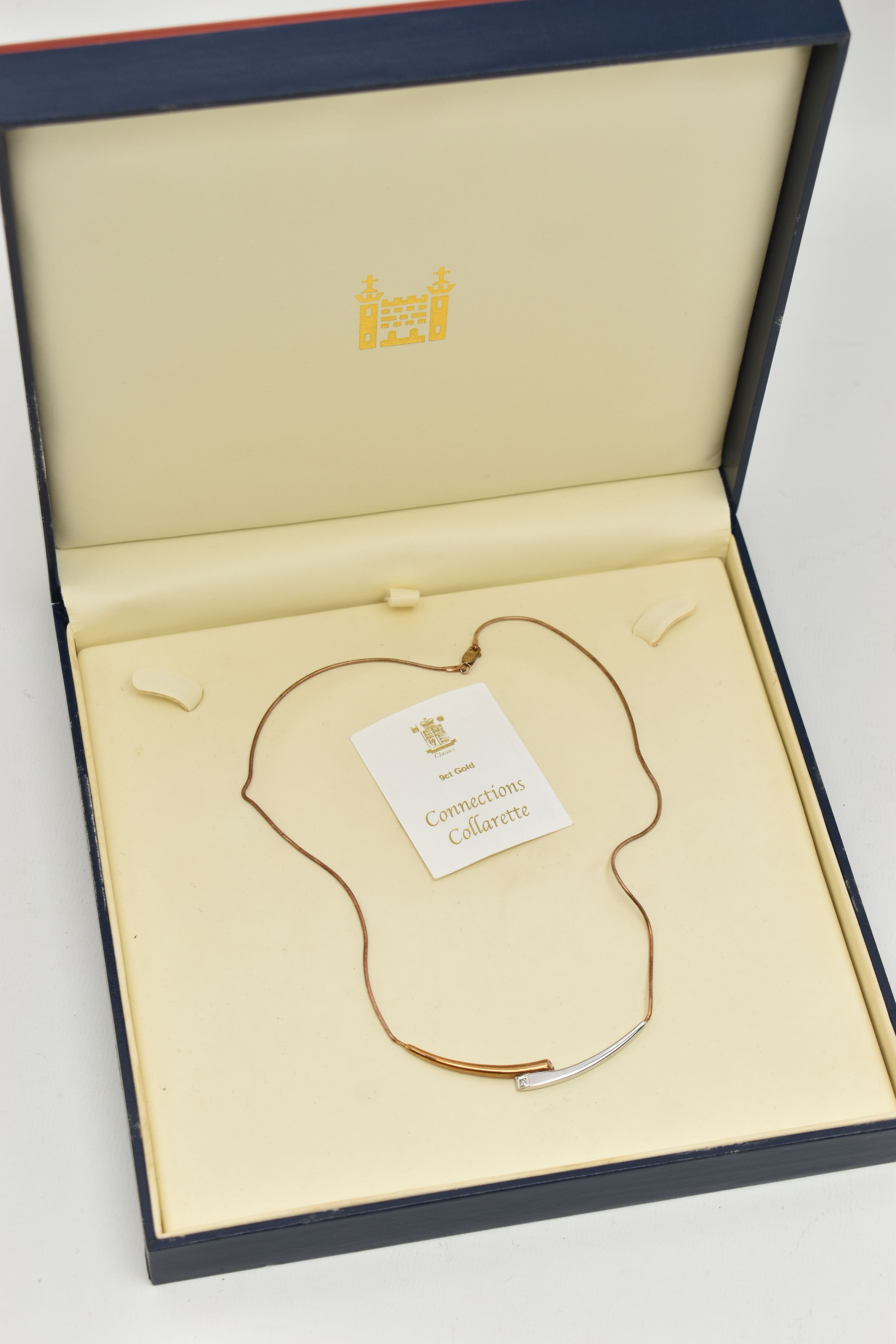 A 9CT GOLD 'ROYAL MINT' 'CONNECTIONS COLLARETTE' NECKLACE, a bicolor bypass style necklace, flush