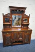 AN EDWARDIAN MAHOGANY MIRROR BACK SIDEBOARD, the top with three bevelled mirror plates, scrolled and