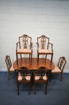 A 20TH CENTURY MAHOGANY OVAL EXTENDING DINING TABLE, with one fold out leaf, length 145cm x depth