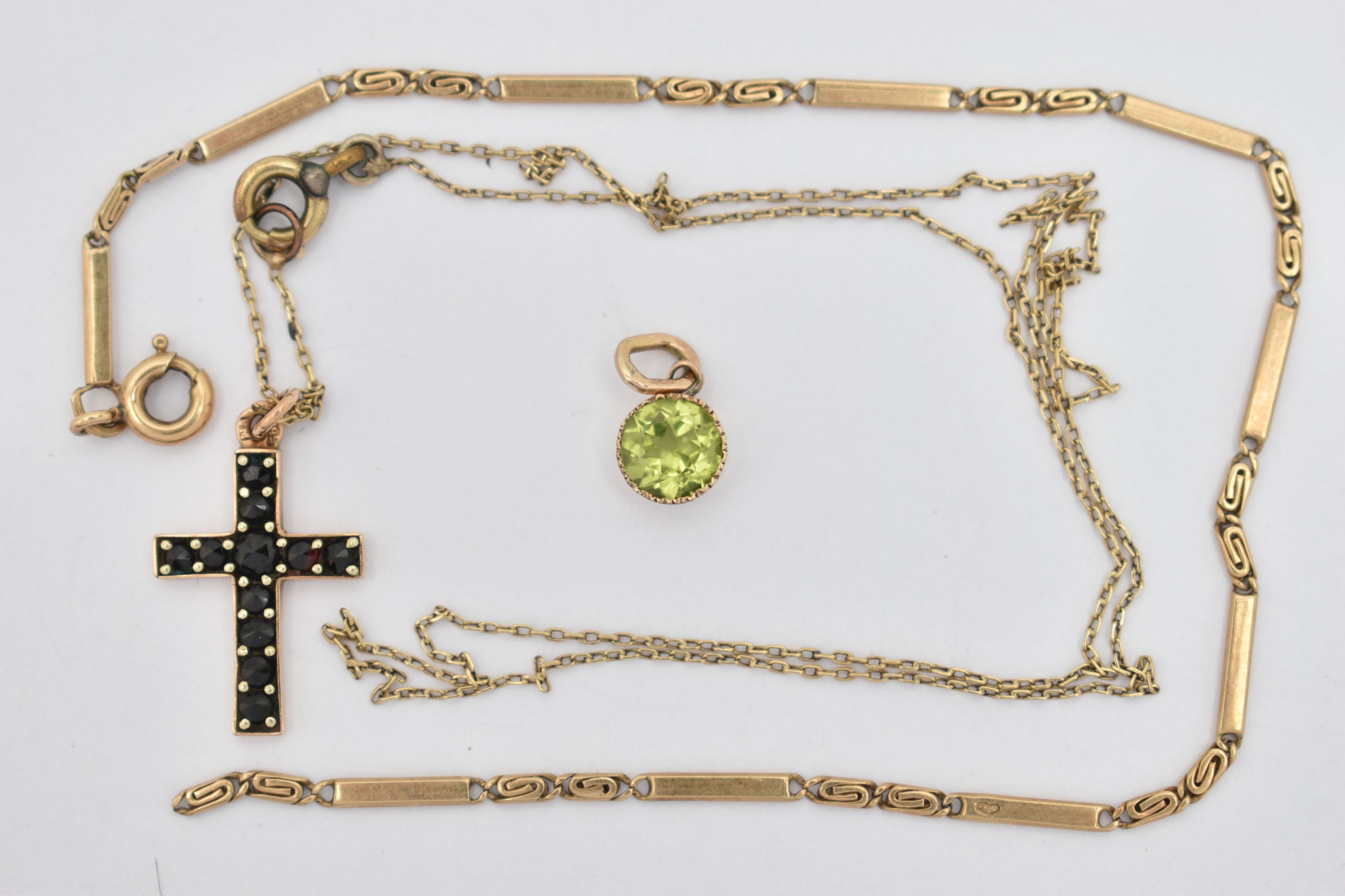 THREE ITEMS OF JEWELLERY, to include a yellow metal, gem set cross pendant suspended from a fine