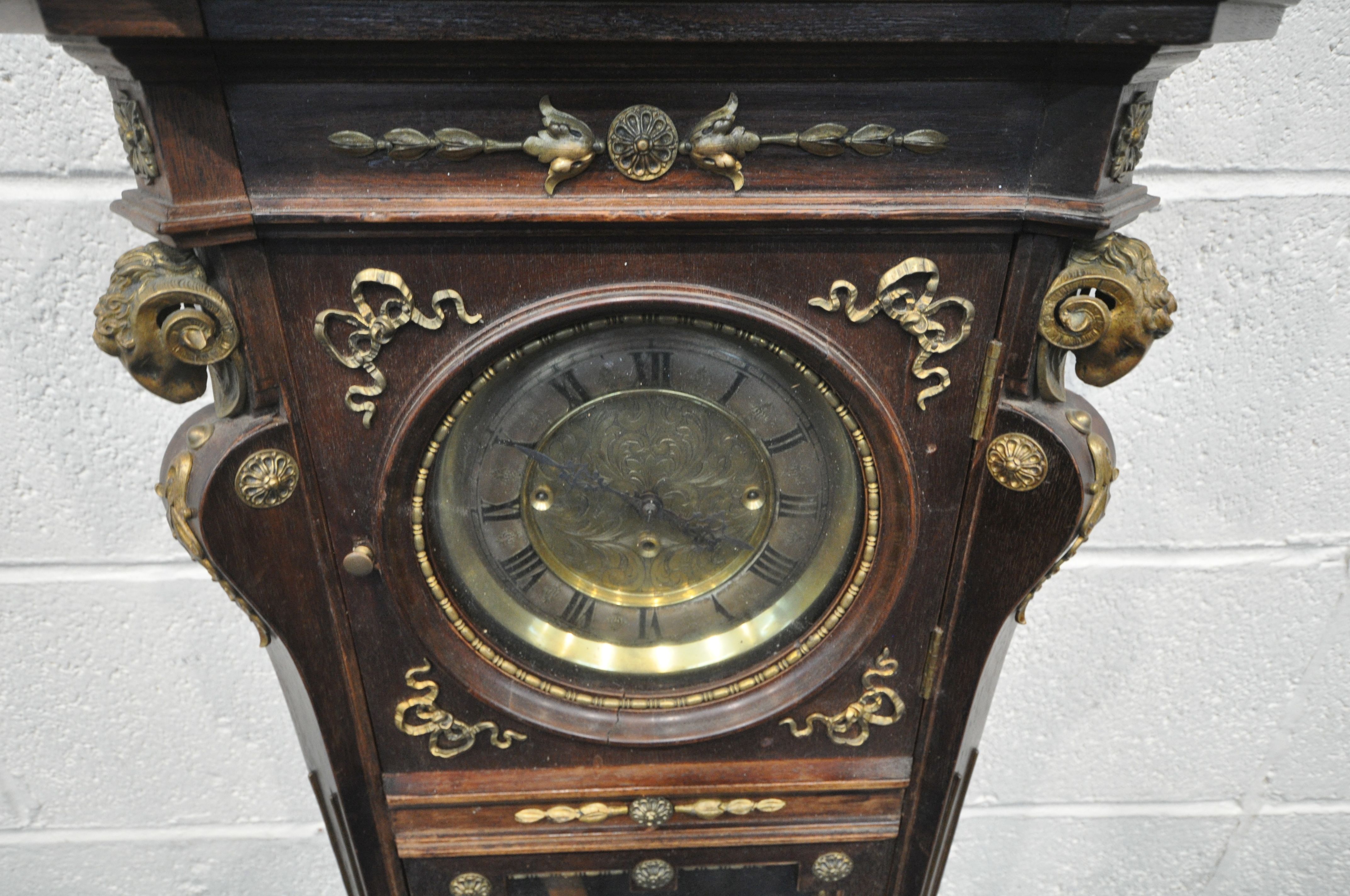 A 20TH CENTURY OAK CASED WALL CLOCK, with a variety of brass decorations, to include masks, ribbons, - Image 3 of 11