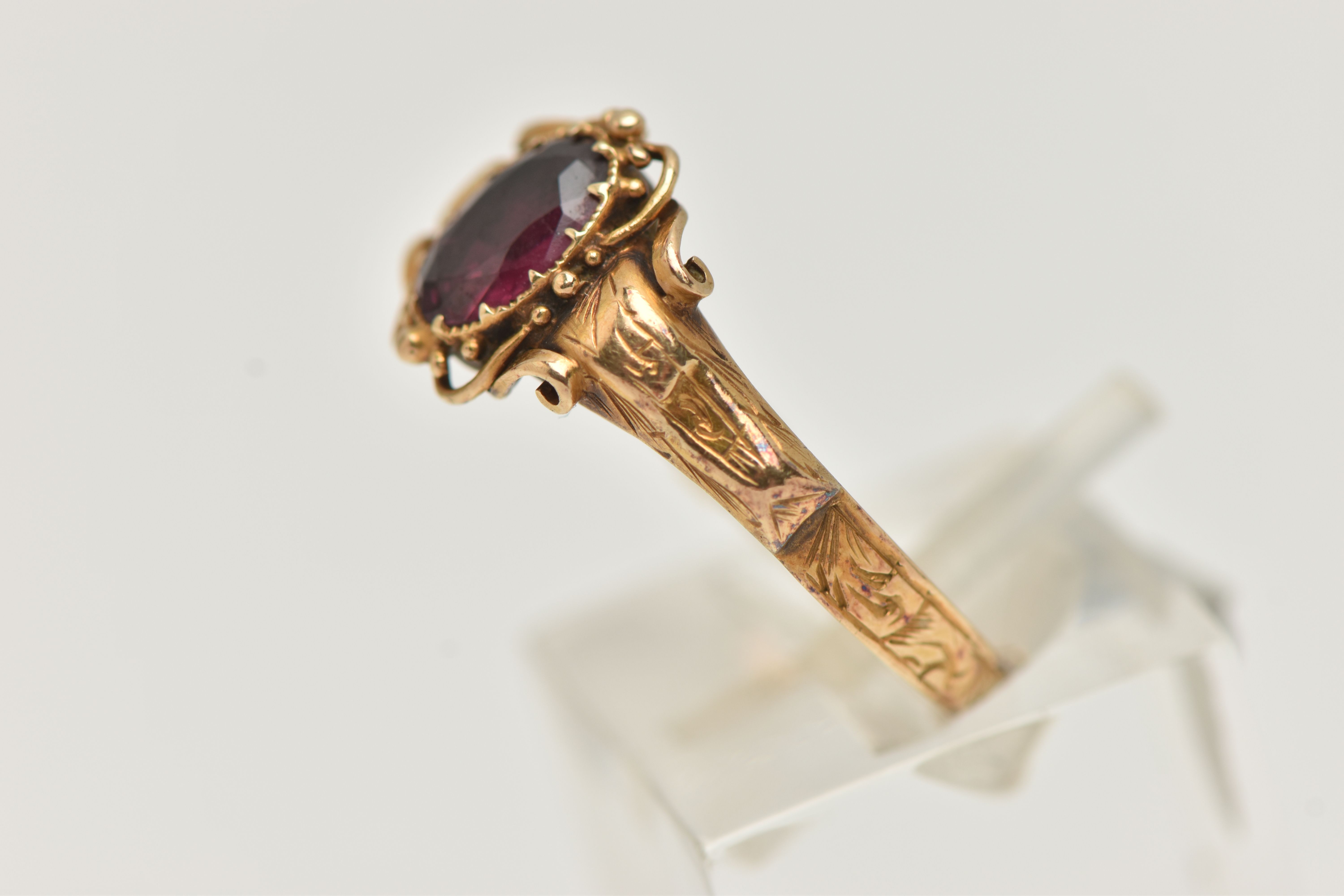 A VICTORIAN YELLOW METAL GARNET RING, centering on an oval cut garnet, claw set, the reverse of - Image 2 of 4