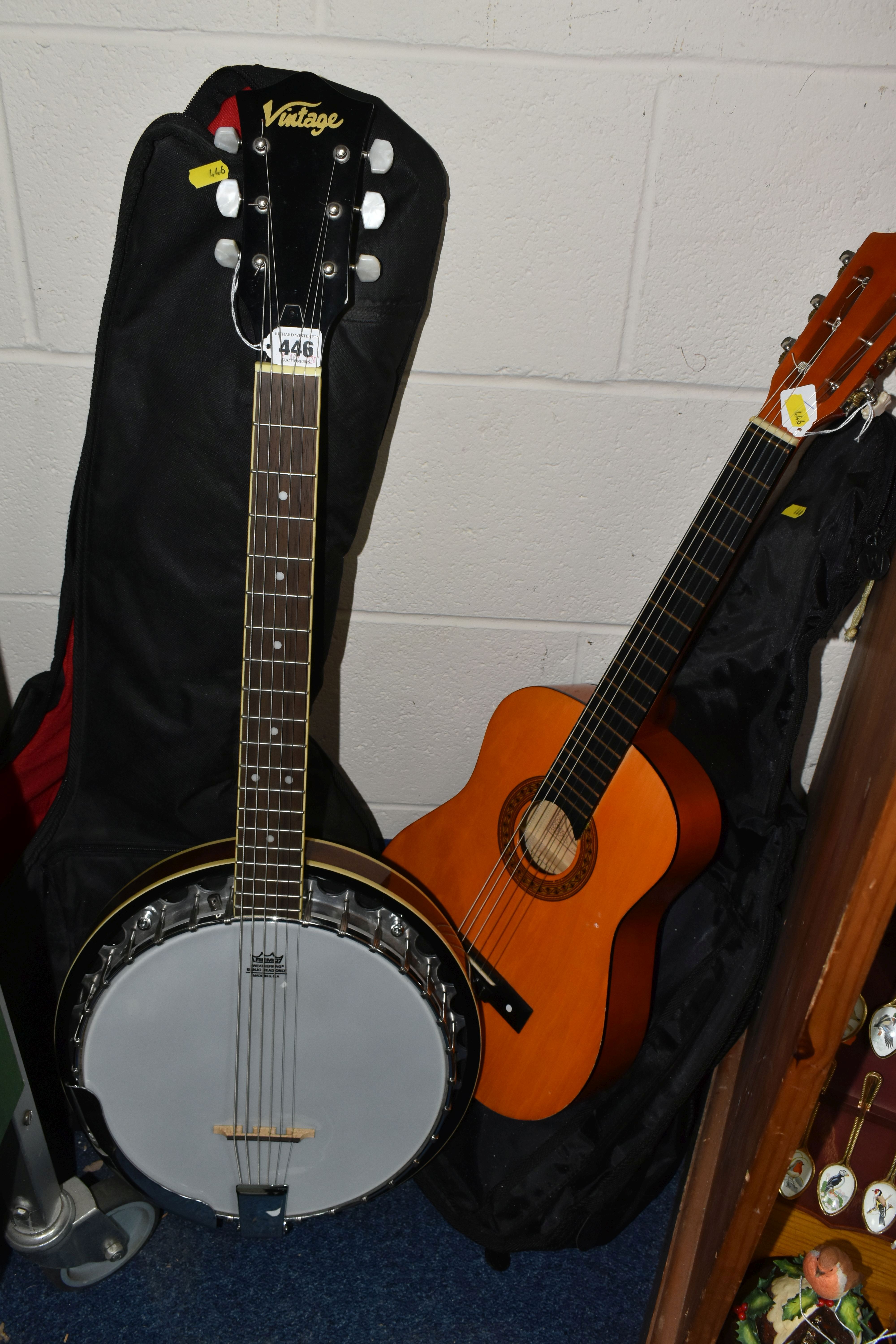 A 'VINTAGE' BANJO AND CHILD'S ACOUSTIC GUITAR, comprising a six string banjo with a soft case and