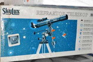 A BOXED 'SKYLUX' REFACTOR TELESCOPE, 70m f/7 on an equatorial mount and tripod, with instructions