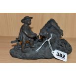 A BRONZE INKWELL, in the form of a dog in a kennel with a small child, unsigned, base width 15.5cm x